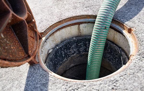 signs that a grease trap needs pumping include slow drainage, foul odors, and visible grease buildup in the trap